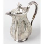 An Edwardian silver hot water pot.