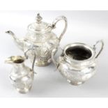 A silver plated three piece tea set, together with three cocktail shakers. (6)