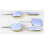 A 1930's silver and guilloché enamel part dressing table set, together with a cased