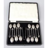 A 1930's cased set of twelve silver teaspoons & a pair of sugar tongs, together with a similar