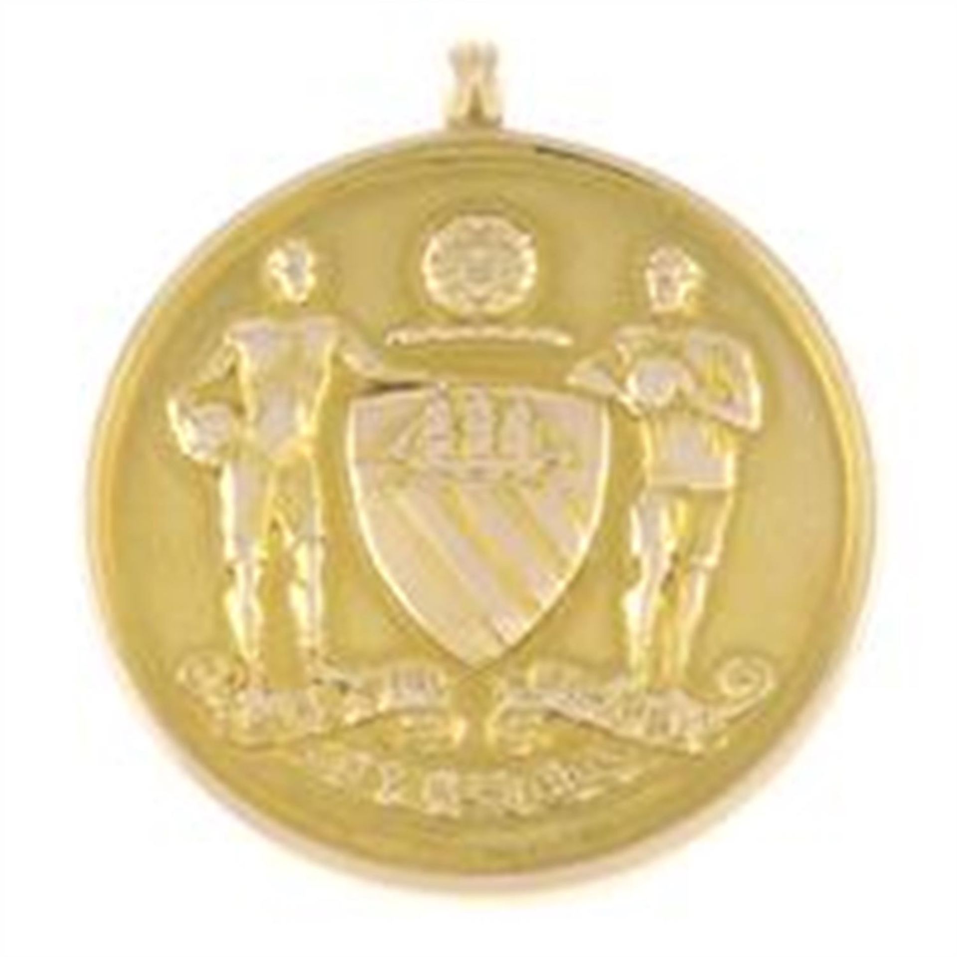 A gold Manchester City English Cup Medal, awarded to William (Billy) Marsden Holmes in 1904.