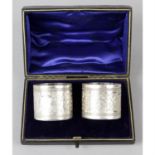 A cased pair of late Victorian silver napkin rings, together with four further silver napkin rings.