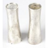 A pair of cased silver salt and pepper pots by Garrard.