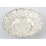 A late Victorian silver embossed circular dish.