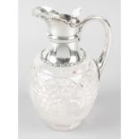 An Edwardian silver mounted & cut glass claret jug.