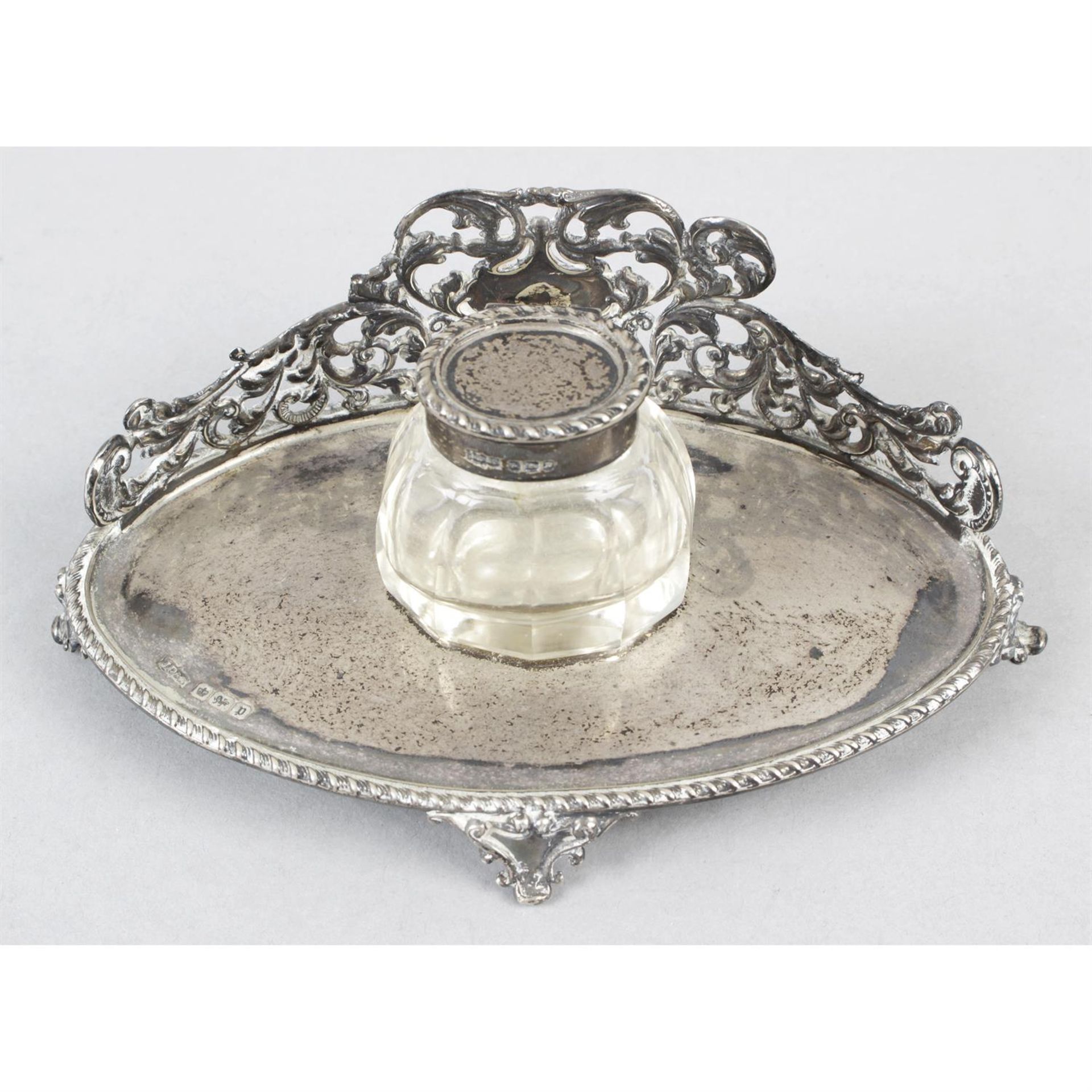 A small Edwardian silver inkstand with removable silver mounted glass inkwell.