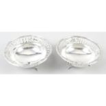 A pair of George V silver pierced circular dishes.