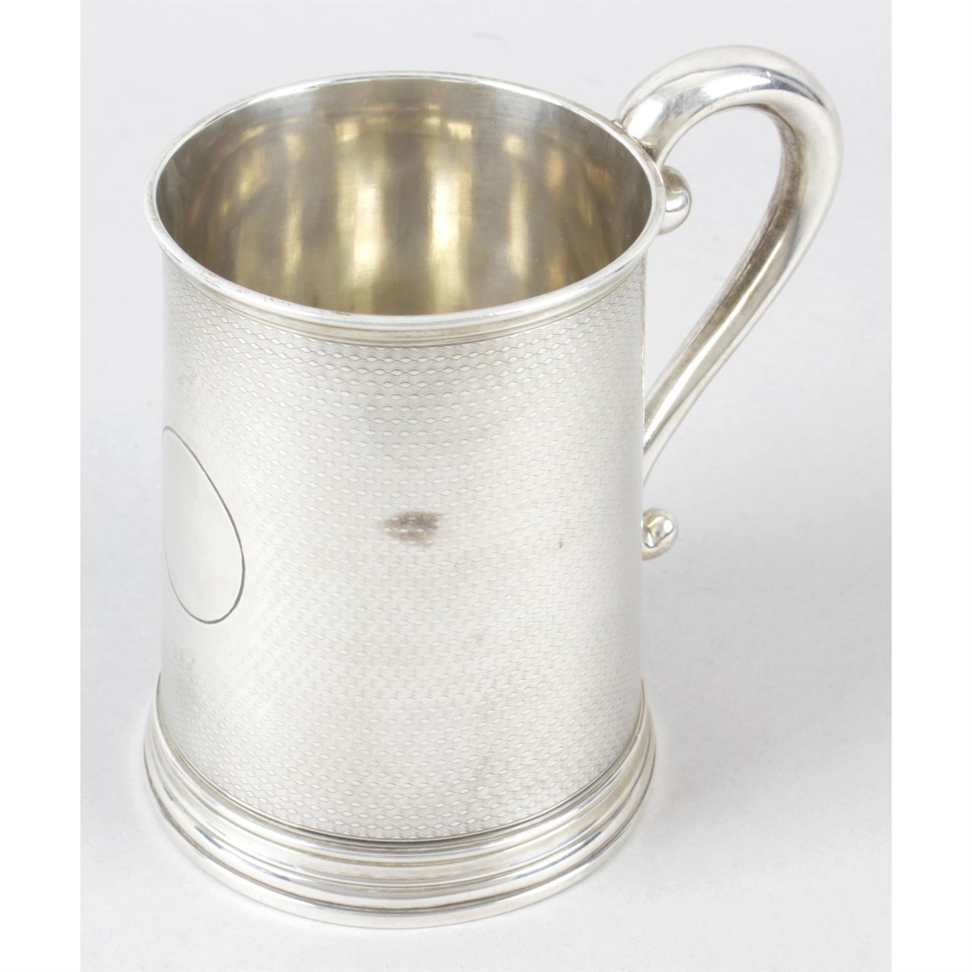 A mid-Victorian silver mug of tapered cylindrical form.