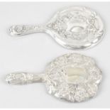 Two Edwardian silver mounted hand-held mirrors. (2).