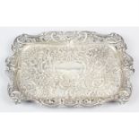 An Edwardian silver embossed dressing table tray.