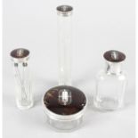 Four 1930's silver & tortoiseshell lidded glass vanity pots.