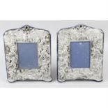 A pair of cherub embossed photograph frames.