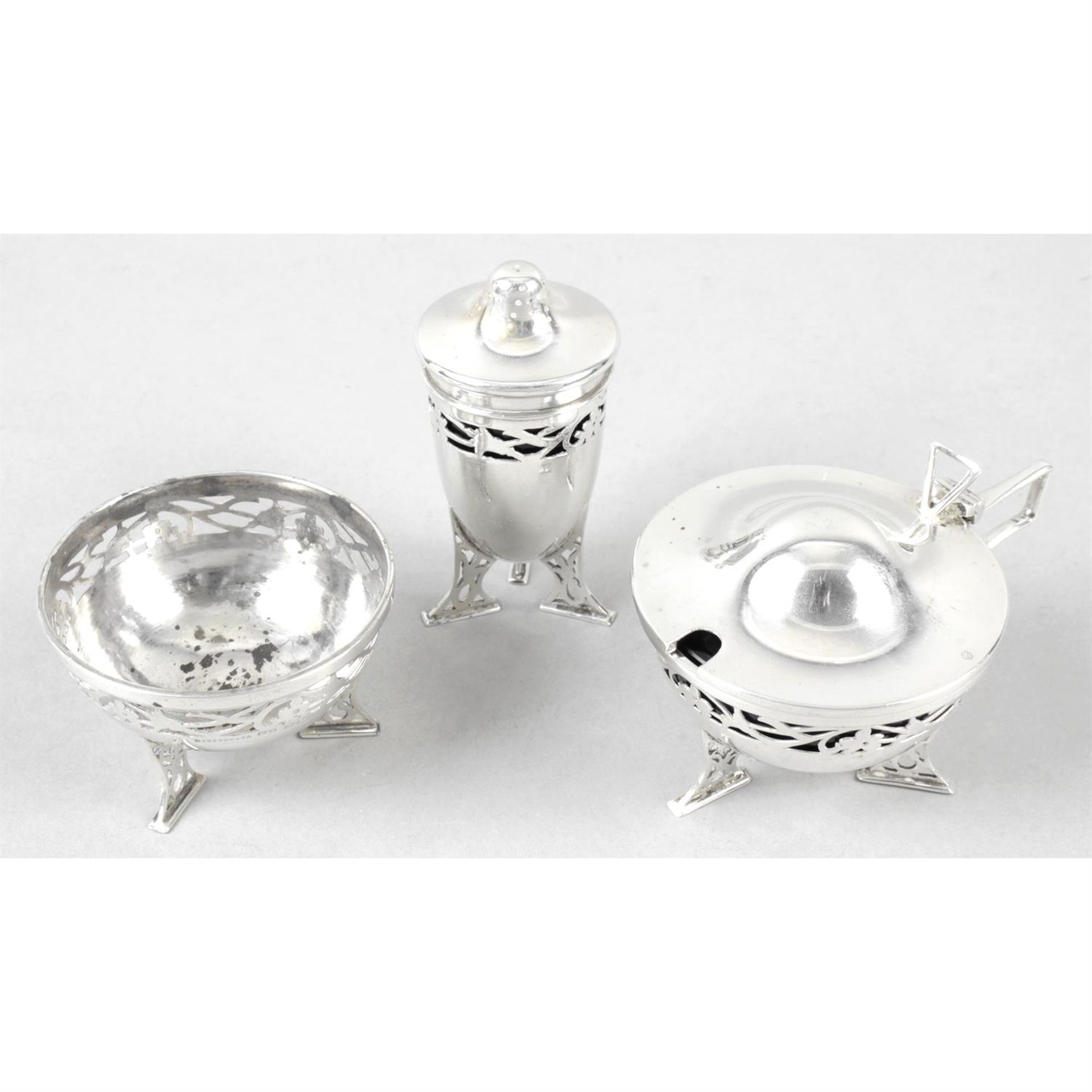 A George V silver pierced three-piece part condiment set.