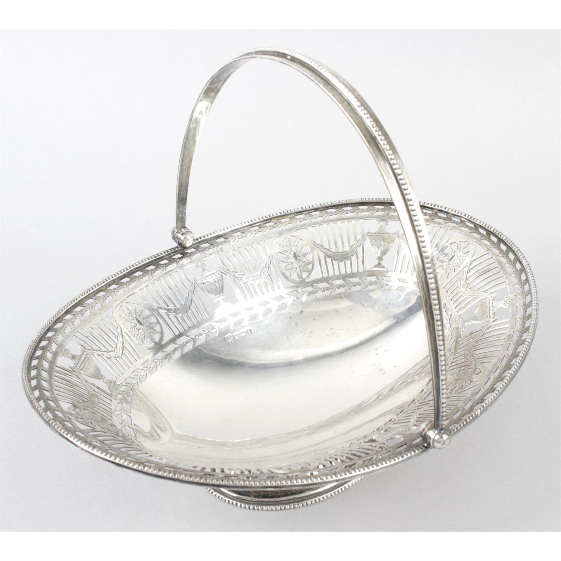 An early George V silver pierced pedestal dish with swing handle.