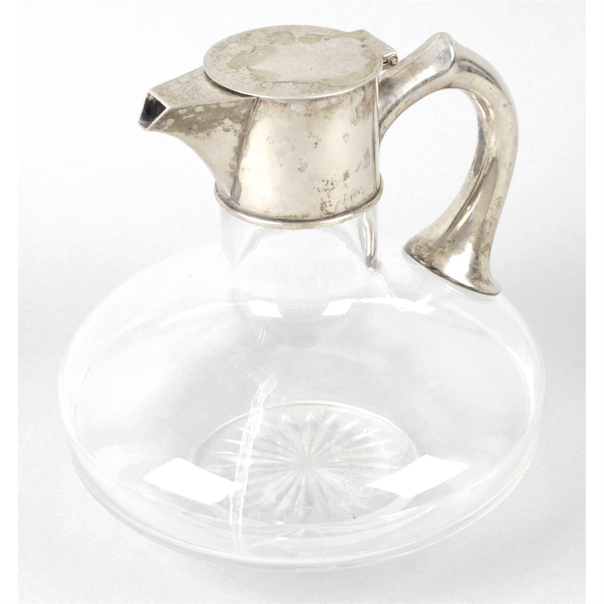 A late Victorian silver mounted and clear glass claret jug.