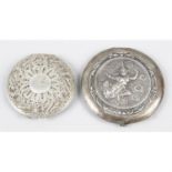 A filigree cased compact or travelling mirror, together with a compact decorated with a deity,