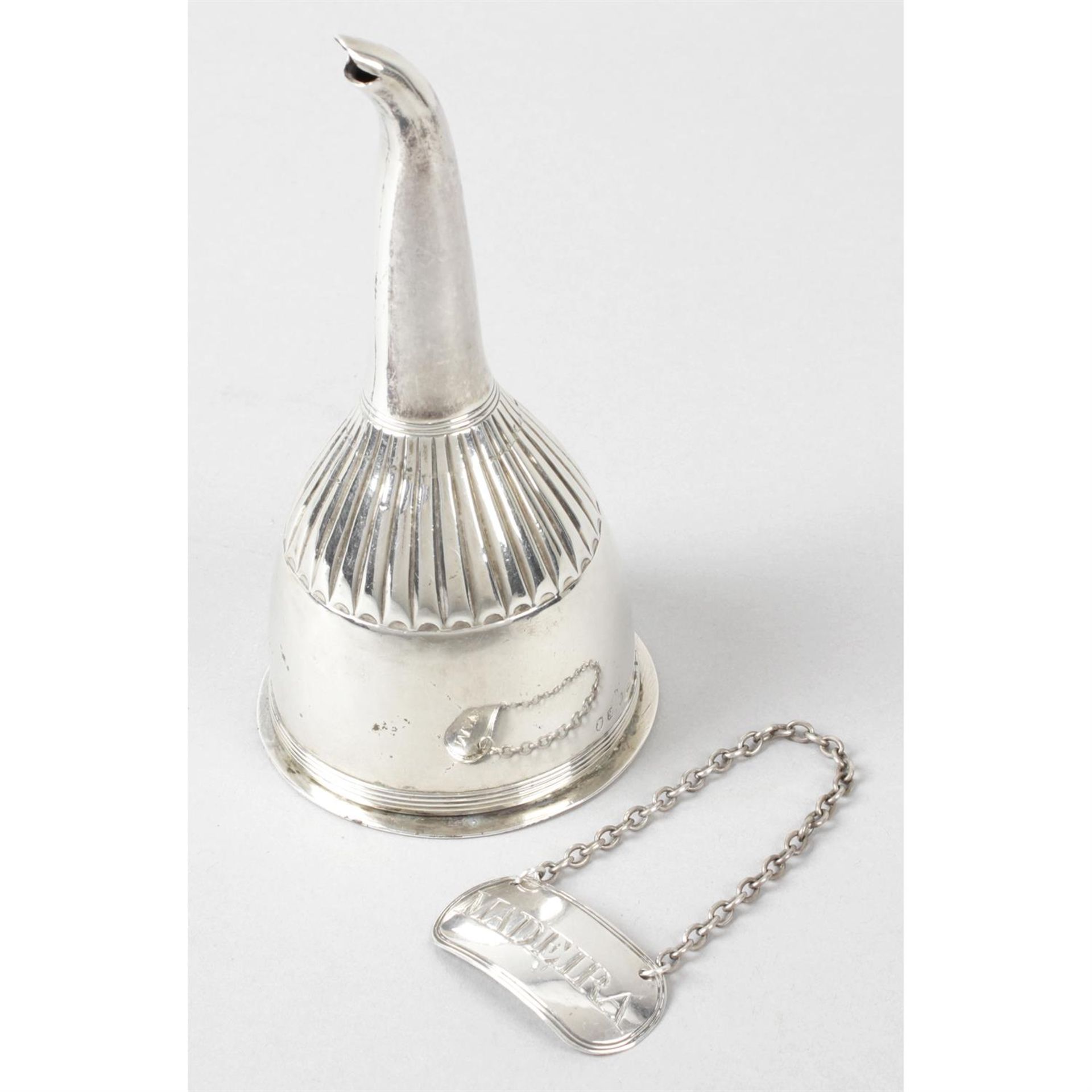 A George III silver wine funnel, together with a Madeira wine label. (2).