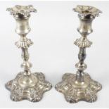 A pair of Edwardian silver candlesticks, in Georgian style (filled).