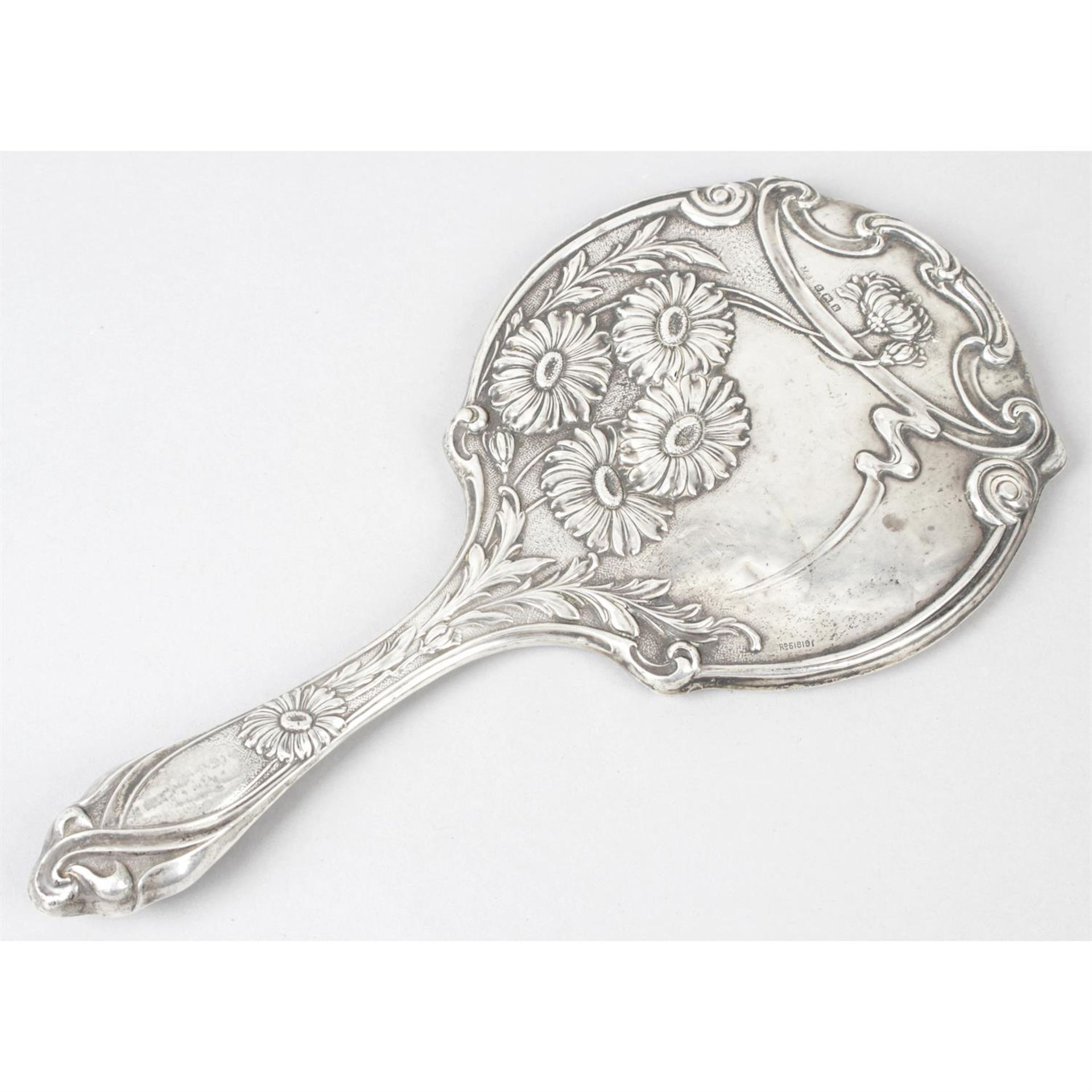 An Edwardian silver mounted Art Nouveau style hand-held mirror.