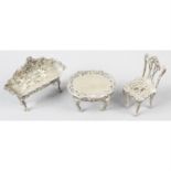 Three modern silver miniatures or toys, to include a settee, chair and table. (3).