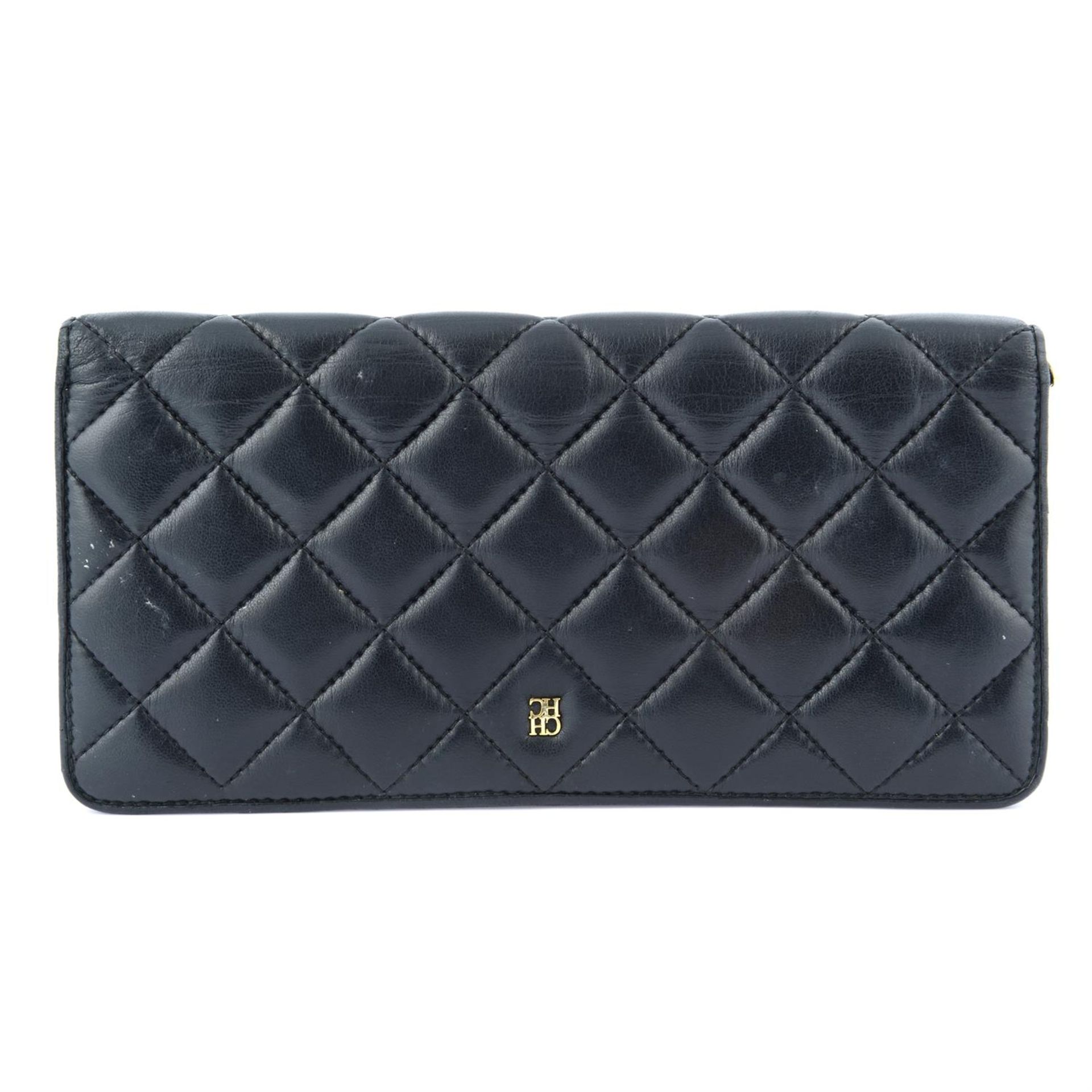 CAROLINA HERRERA - a black quilted leather wallet.