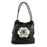 CHANEL - a black leather Camellia tote bag.