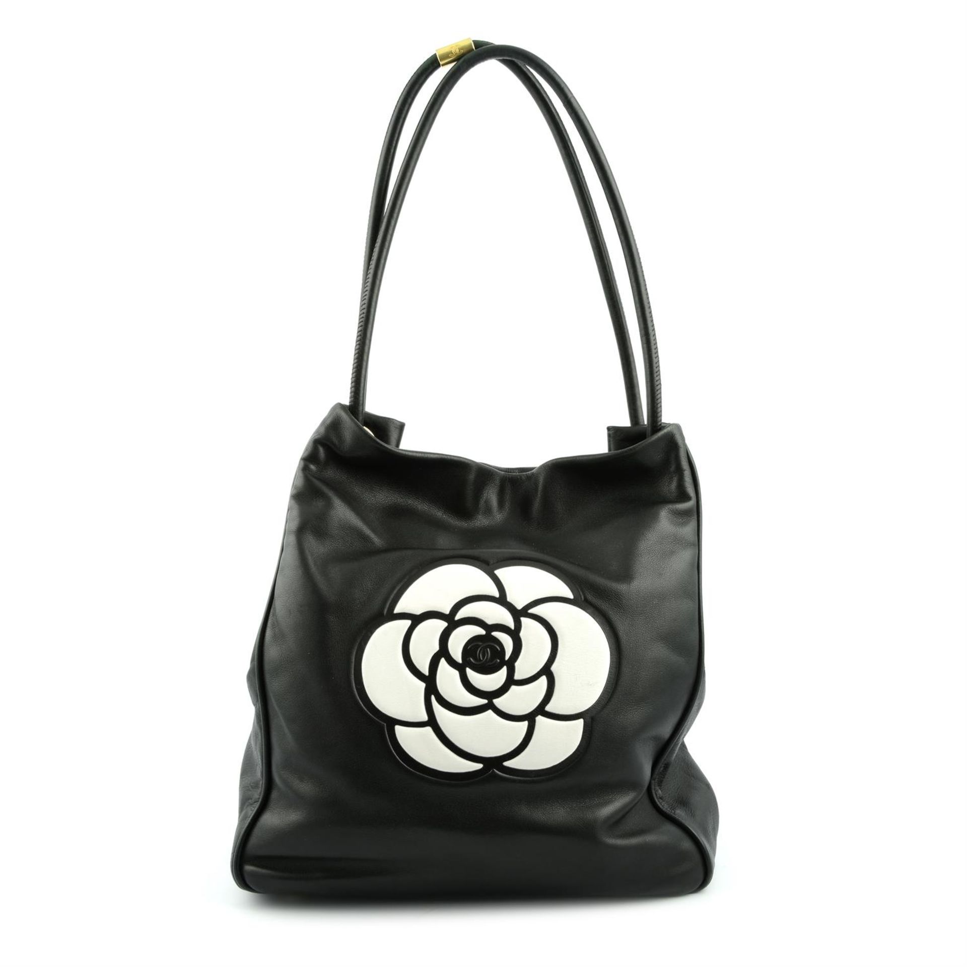 CHANEL - a black leather Camellia tote bag.