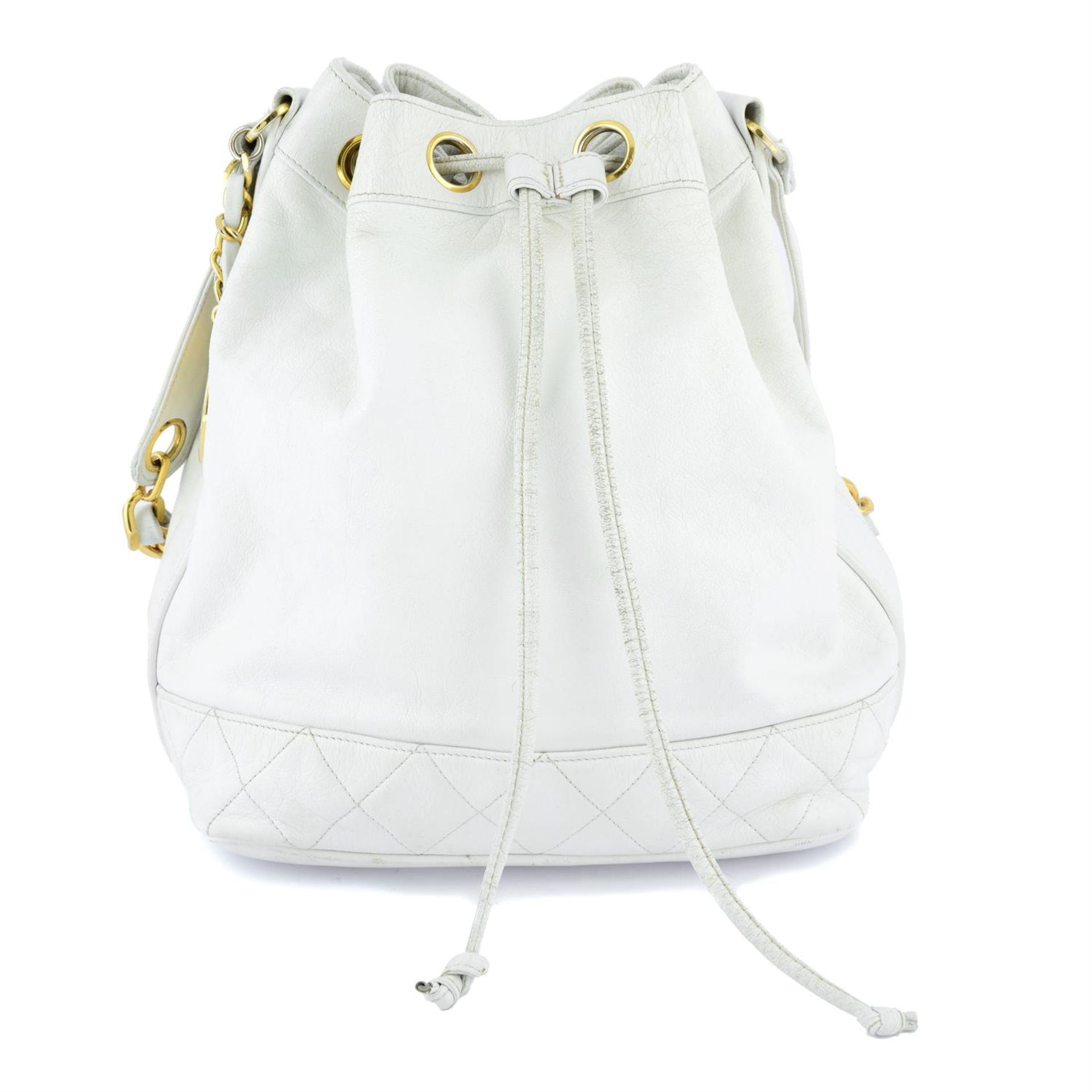 CHANEL - a circa 1990 white leather bucket bag.