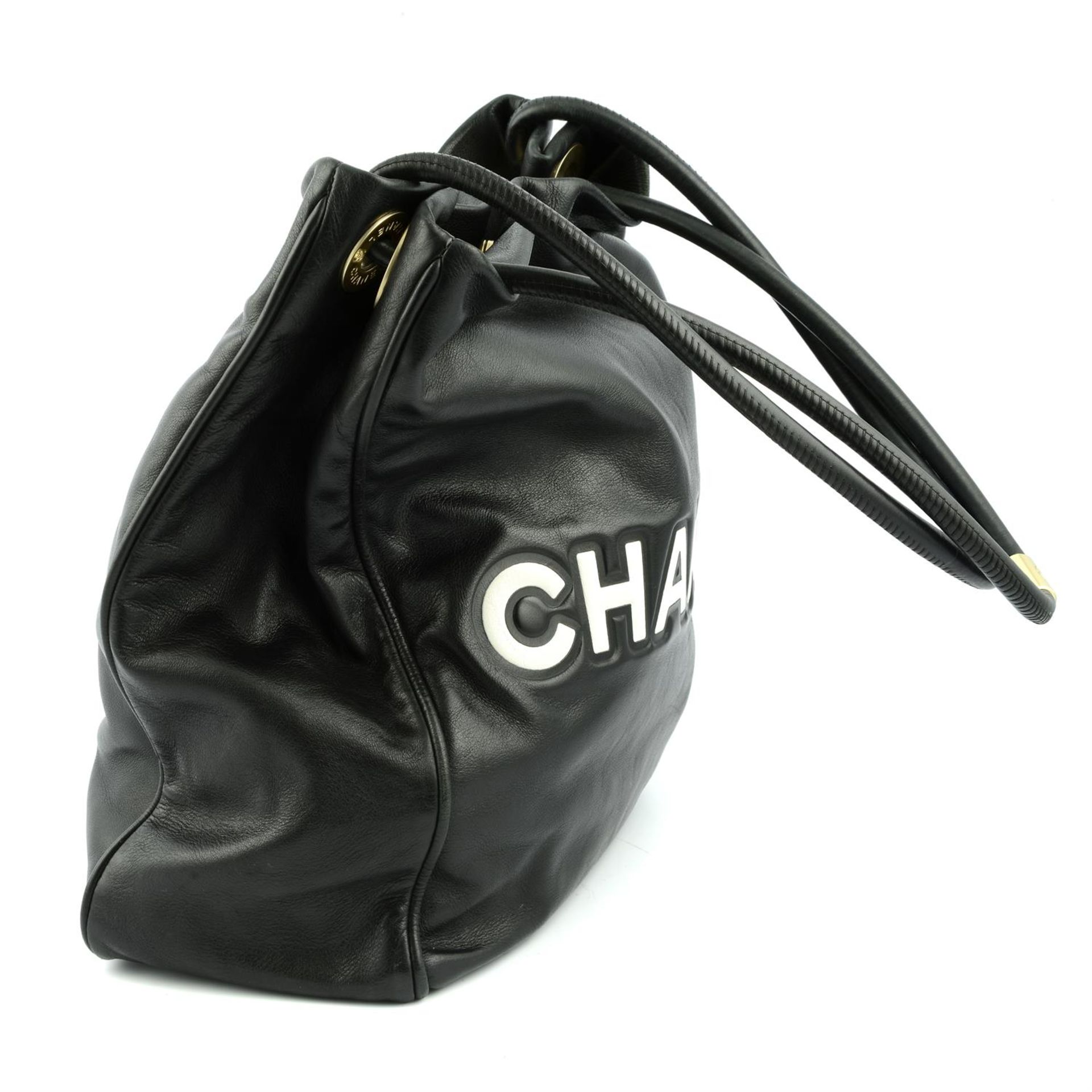 CHANEL - a black leather Camellia tote bag. - Image 3 of 5