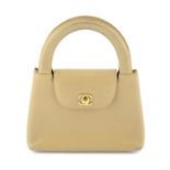 CHANEL - a beige Lambskin Kelly handbag.