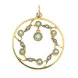 An early 20th century peridot and split pearl ornate openwork pendant.