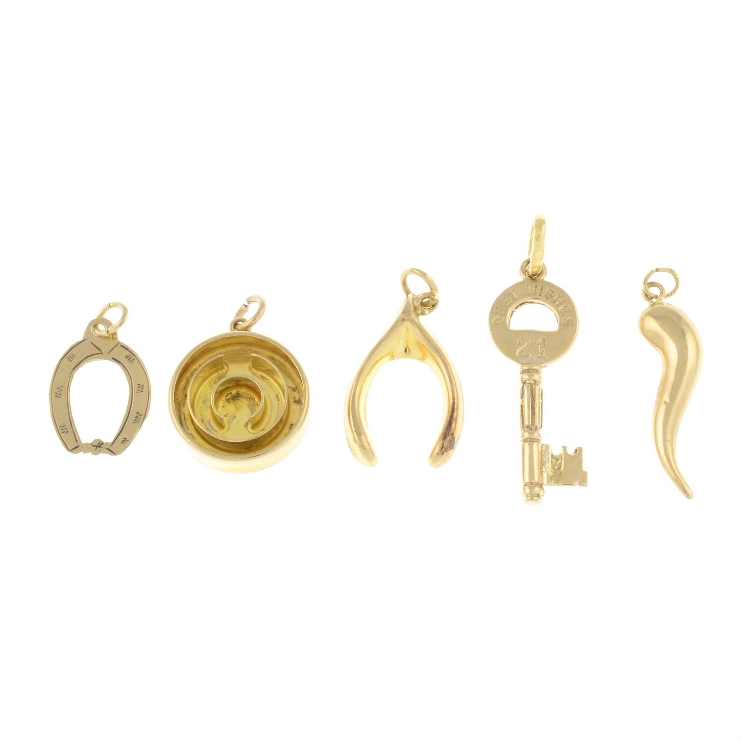 Five charms, to include a 9ct gold 21st birthday key.