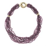 A 9ct gold garnet beaded nine-strand necklace.