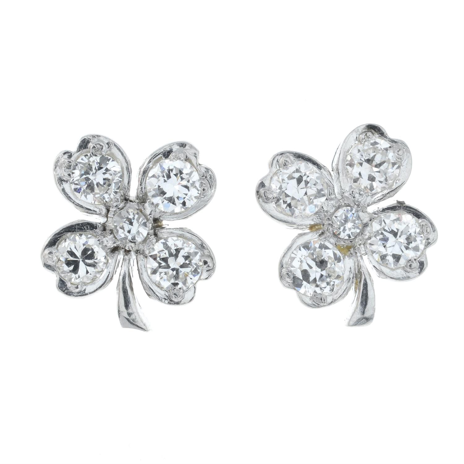 A pair of diamond four-leaf clover earrings.