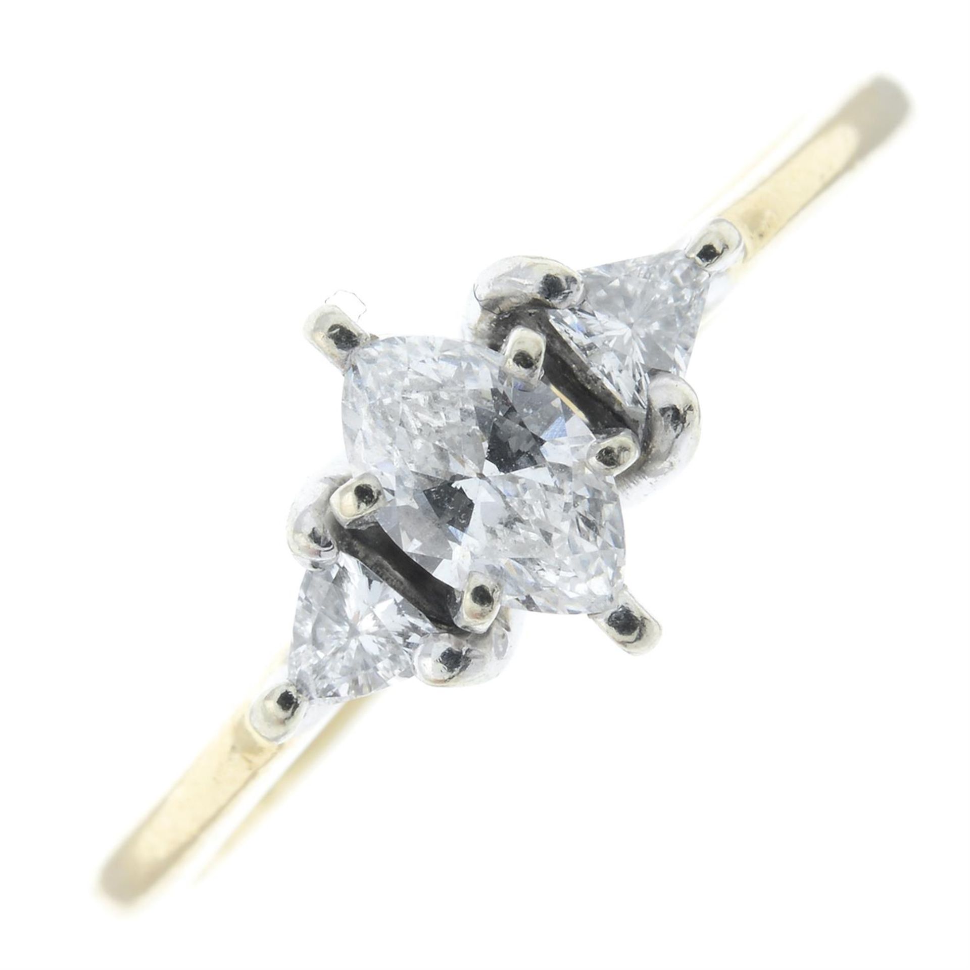 A marquise-shape and triangular-shape diamond three-stone ring.