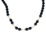 An onyx and rock crystal bead single-strand necklace.