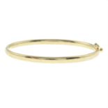 A 9ct gold hinged bangle.