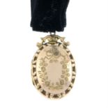 A late Victorian 9ct gold front and back floral motif engraved locket on velvet collar.