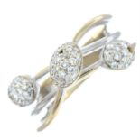 A crossover dress ring, with pavé-set diamond dome highlights.