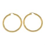 A pair of 9ct gold swirling textured hoop earrings.