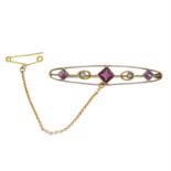 An early 20th century 9ct gold garnet and split pearl bar brooch.