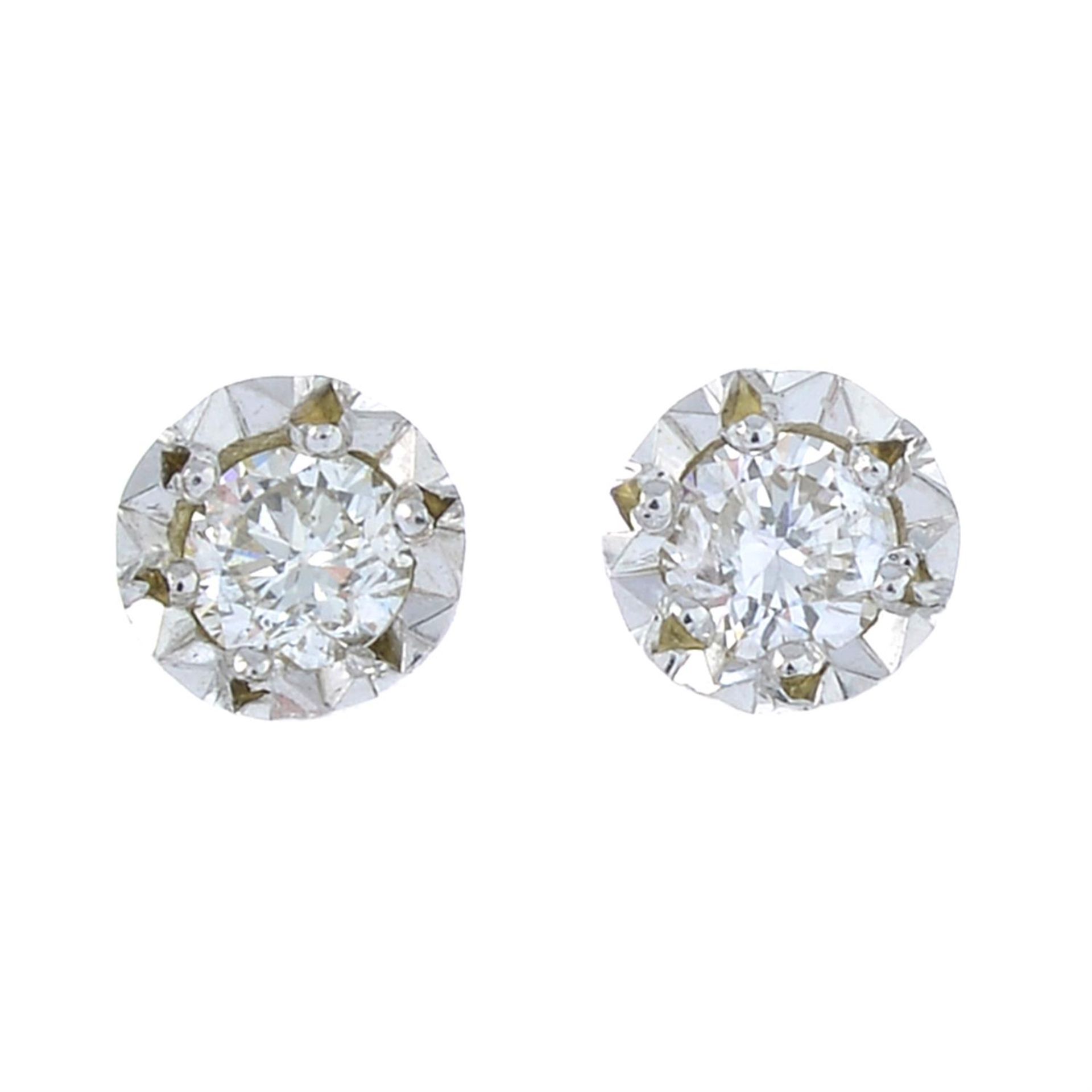 A pair of 9ct white gold illusion-set diamond stud earrings.