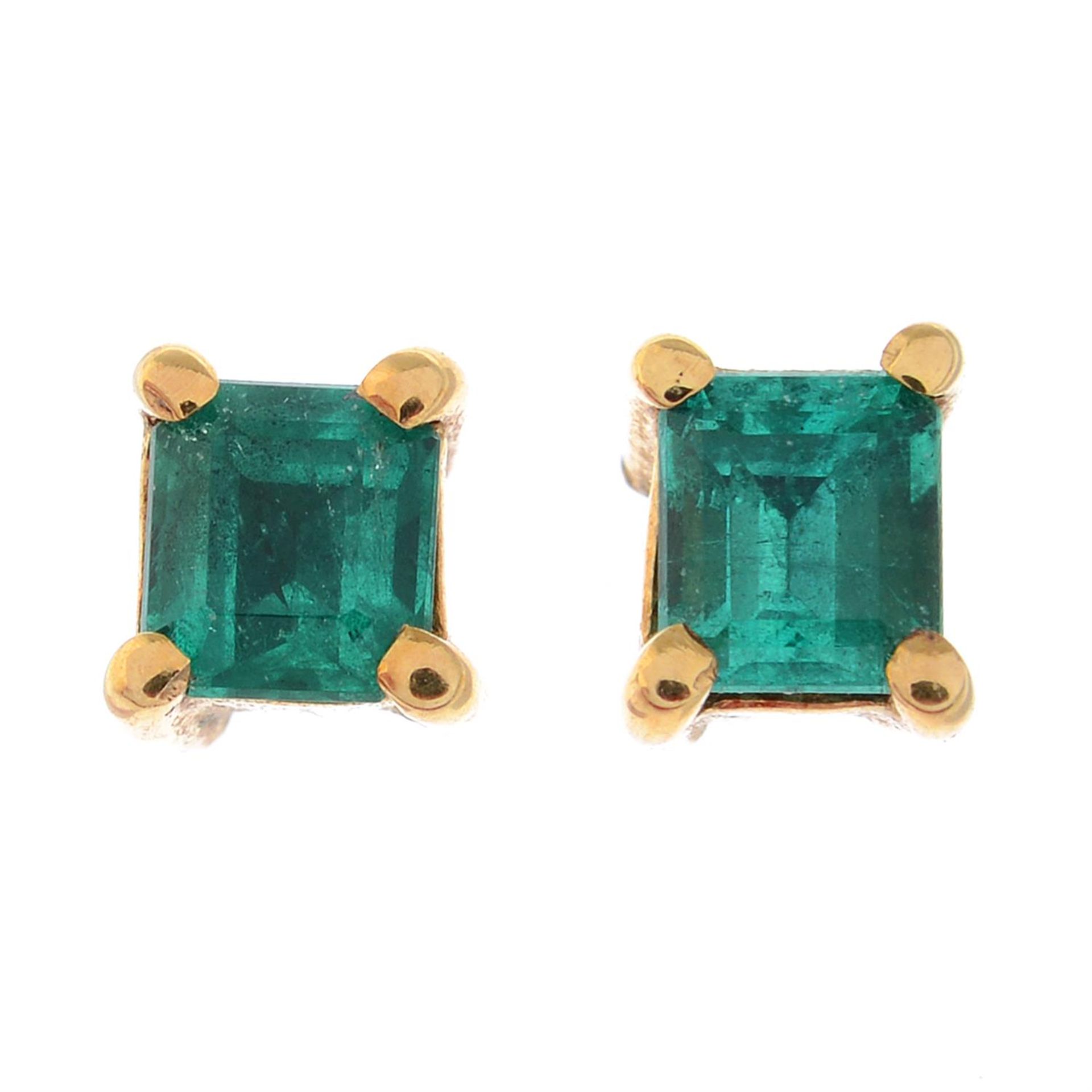 A pair of emerald stud earrings.