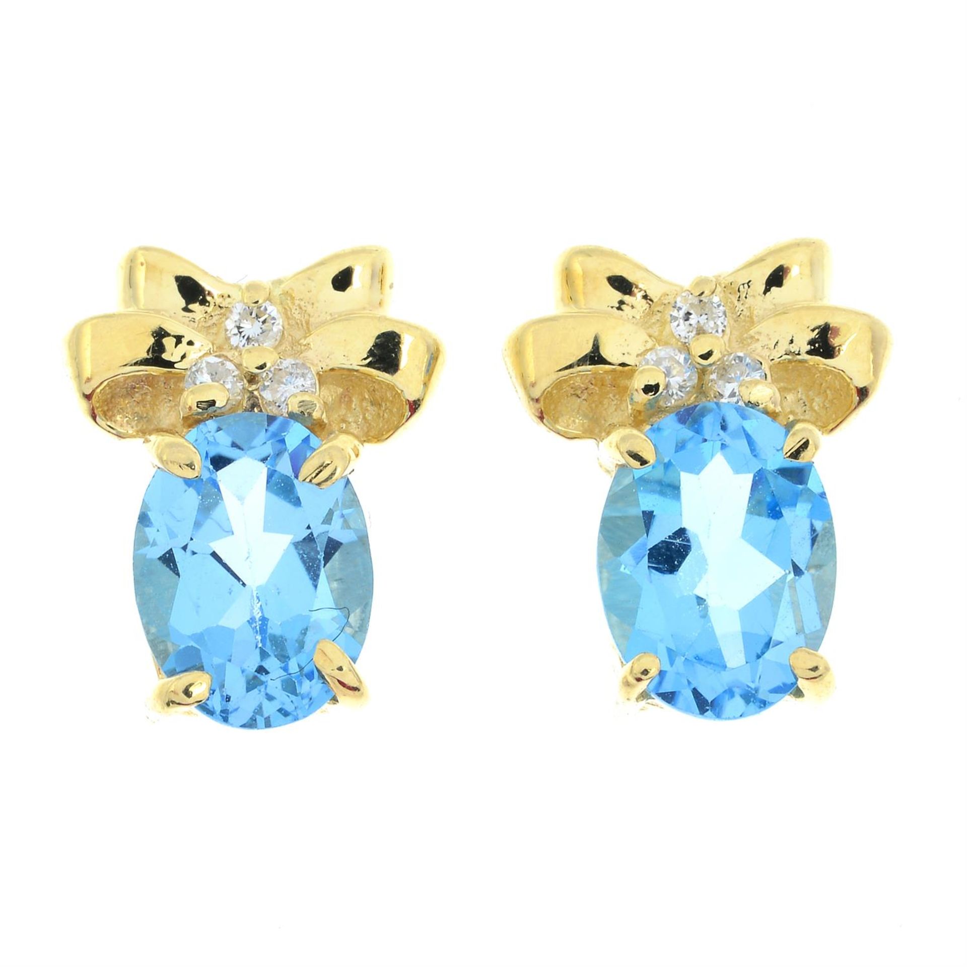 A pair of blue topaz and diamond earrings.