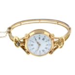 An early 20th century 15ct gold hinged bangle with mounted 18ct gold fob watch.