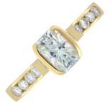 An 18ct gold synthetic moissanite ring, with synthetic moissanite shoulders.