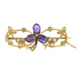 An early 20th century gold amethyst, demantoid garnet and split pearl floral brooch.