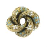 A 19th century gold enamel floral swirl brooch.