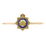 A mid 20th century 15ct gold 'The Devonshire Regiment' enamel brooch.