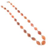 An early 20th century graduated carnelian bead necklace, with rock quartz spacers.